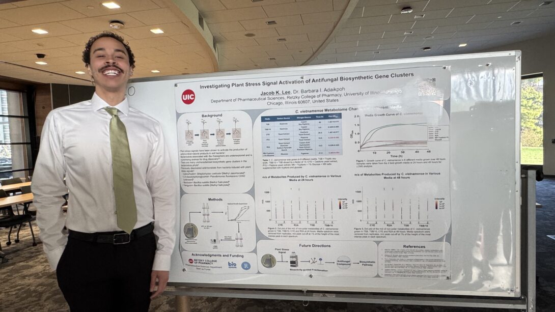 Jake standing by his poster at MIKIW 2026
